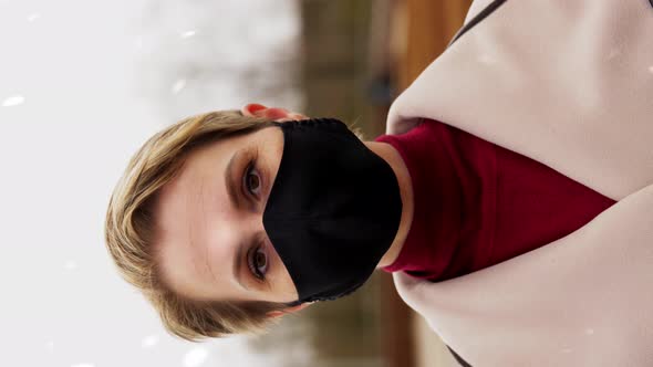 Woman Wearing Reusable Protective Mask in Winter