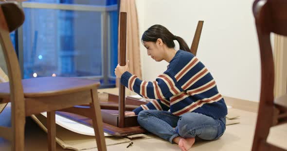 Woman assemble the table at home