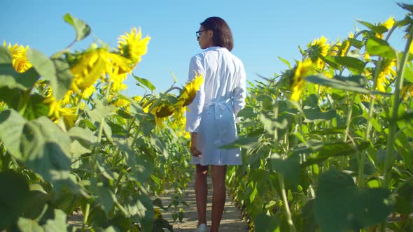 Female Agronomist Walking Along Cultivated Field