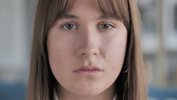 Close Up of Face of Casual Young Girl Looking at Camera