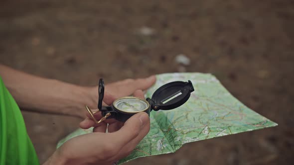 Survivalist Planning Trip with a Map and Compass