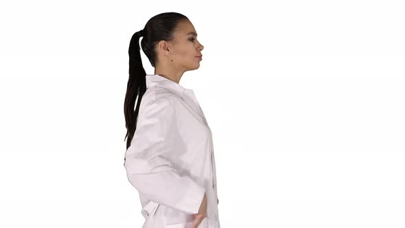 Young Woman Pharmacist in White Gown Coat Uniform Walking on White Background.