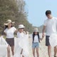 Asian family picking up plastic bottle to trash bag on the outdoor beach. - VideoHive Item for Sale