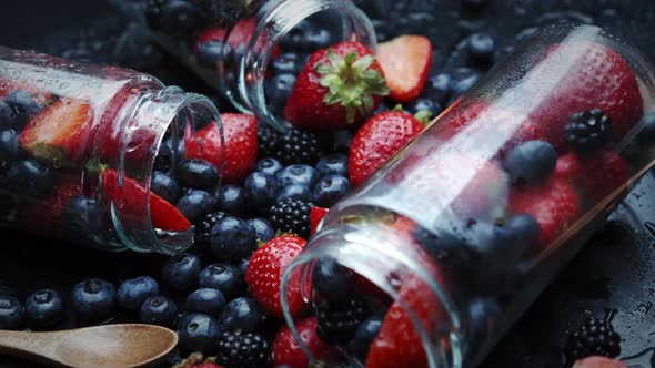 Cooking Raspberry and Blueberry Berry Jam. Place in a Glass Jar.. Rotation on a Black Background