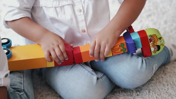 Cropped View of Designing Construction From Colorful Bricks at Home