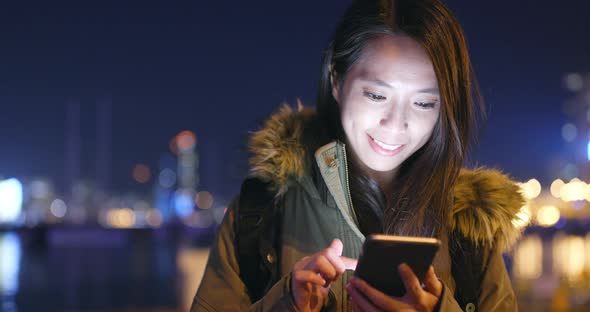 Young Woman Use of Smart Phone in City at Night