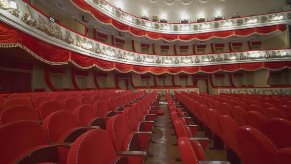 Beautiful vacant theater. Large hall with comfortable red armchairs 