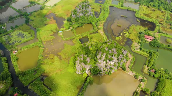 Aerial: North Vietnam karst landscape at sunset, drone view of Ninh Binh region, tourist destination