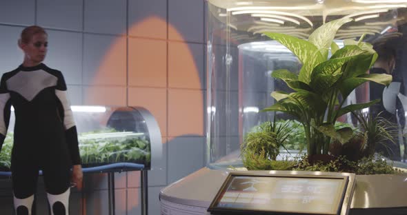 Female Astrobiologist Checking Plant Incubators alt
