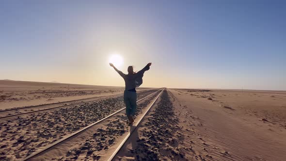 Young Woman Walks at Abandoned Railway Near Garub Railroad Station