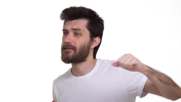 Young Man Dancing to Favourite Music on White Background