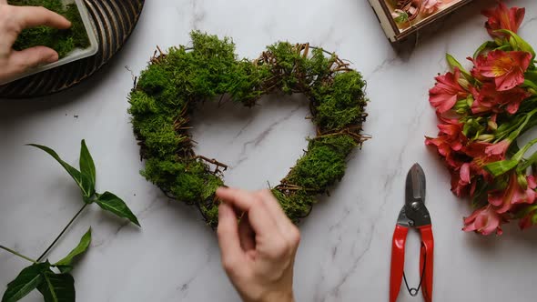 Female Hands Decorates Floral Wreath