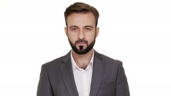 Portrait of Caucasian Bearded Guy Having Mustaches Looking on Camera with Strict Gaze Holding Index