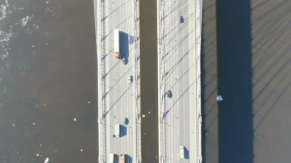 Aerial Shooting, Top View Over a Cable-stayedbridge Over the River, Spring Ice Floats on Water