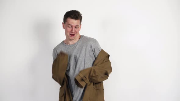 White Guy in a Brown Coat and a Funny Dance on a White Background