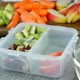 Woman hand put healthy fruit and nut snacks into the lunch box and close it - VideoHive Item for Sale
