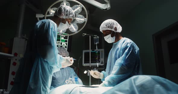 A Team of Surgeons Perform an Operation in a Bright Operating Room