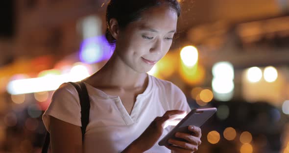 Woman Using Mobile Phone at Night