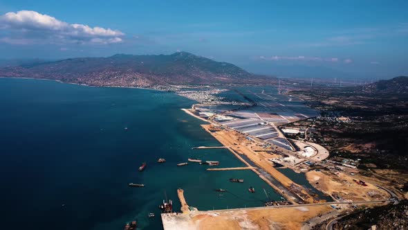 Aerial descending over Ca Na General Port construction sites, Vietnam