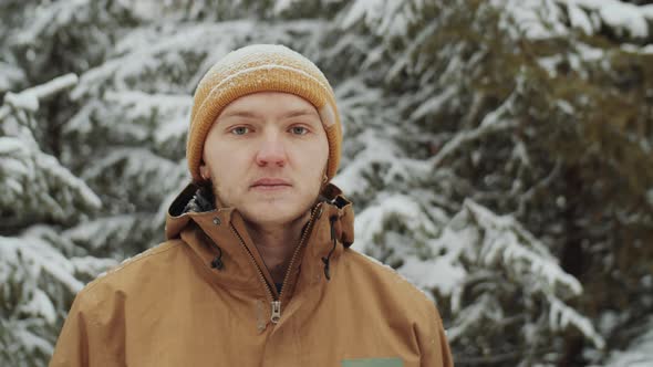 Portrait of Cheerful Man in Winter Forest