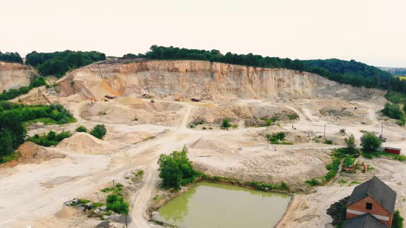 Large Industrial Sand Quarry at the Edge of the Forest. Remains of Sand From a Height. Large-scale