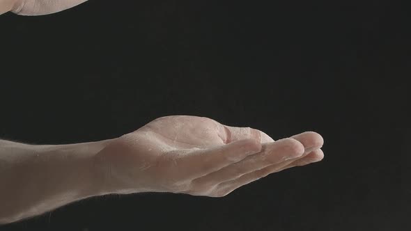 Closeup of Male Hands Shaking Off Flour