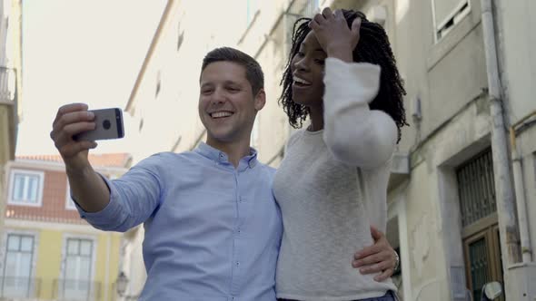 Happy Multiethnic Couple of Tourists Posing for Selfie