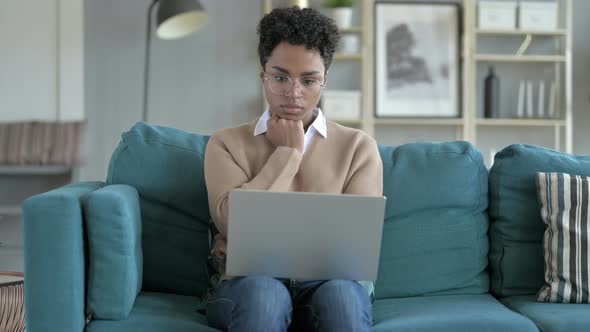 Thoughtful African Girl Working on Laptop