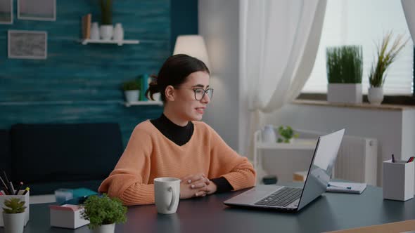 Woman Attending Remote Video Call Lesson on Laptop alt