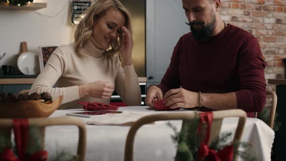 Adult couple making Christmas decoration at the table. Shot with RED helium camera in 8K