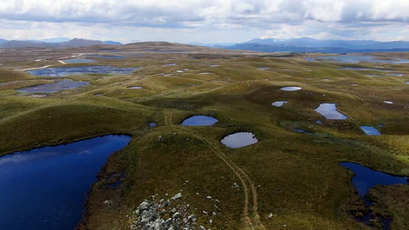 Ponds And Green Hilly Landscape At The Lagoons Of Alto Peru In Cajamarca Peru. Aerial Drone