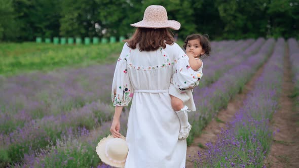Mother Walking with Child on Hands in Lavender Field
