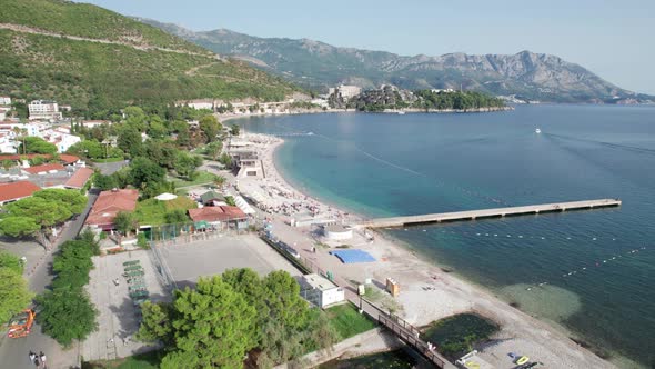 Aerial View Budva Beach By Sea with Sun Loungers and People Seashore Montenegro