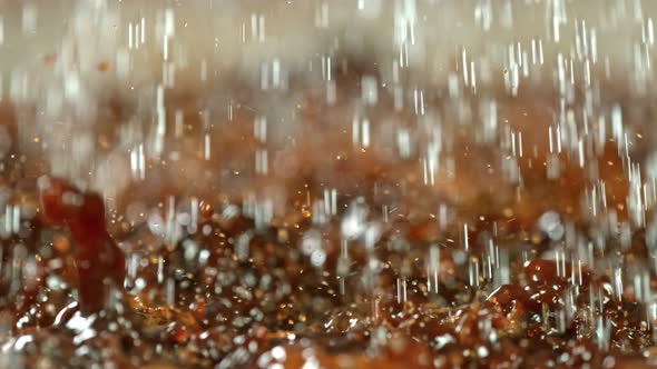 Super Slow Motion Macro Shot of Splashing Fresh Coffee and Water Droplets at 1000 Fps.