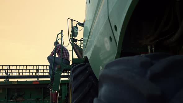 Farmer Resting Combine Field at Sunset