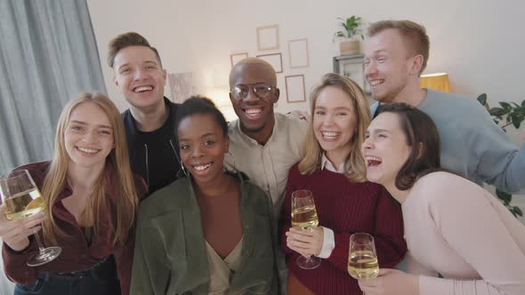 Group of Happy Friends Laughing and Posing at House Party