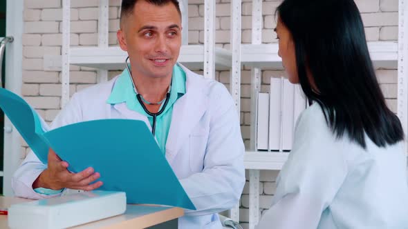 Doctor in Professional Uniform Examining Patient at Hospital