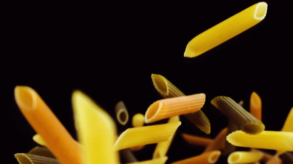 Colored Pasta Falling on a Black Background