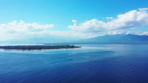 Aerial above panorama of exotic shore beach trip by blue lagoon and white sandy background of a picn