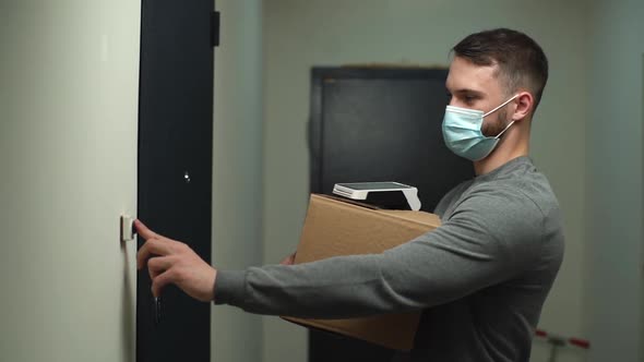 Delivery Man Wearing Medical Mask Coming To Door with Parcel and Contactless Payment Terminal