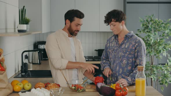 Lgbt Couple in Their New Apartment in the Kitchen Enjoying Cooking Together