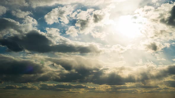 White Fluffy Clouds Slowly Float Through the Blue Daytime Sky Timelapse