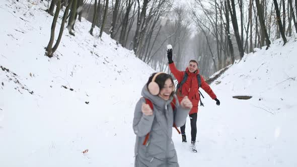 Couple Having Fun By Throwing Snow Balls on Each Other