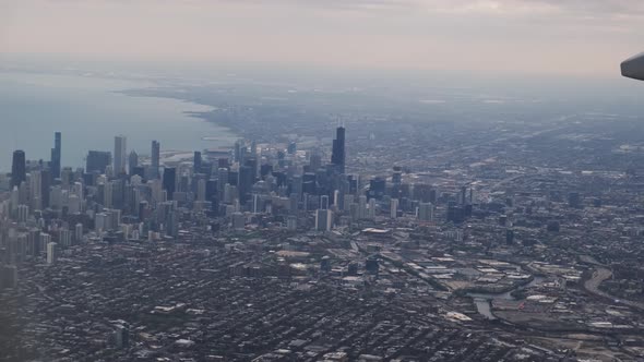 The Plane Flies Over the City of Chicago USA Lands at the Airport