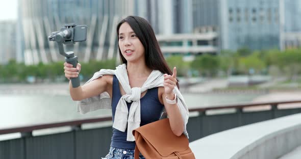 Woman Taking a Vlog on Mobile Phone in Shenzhen City