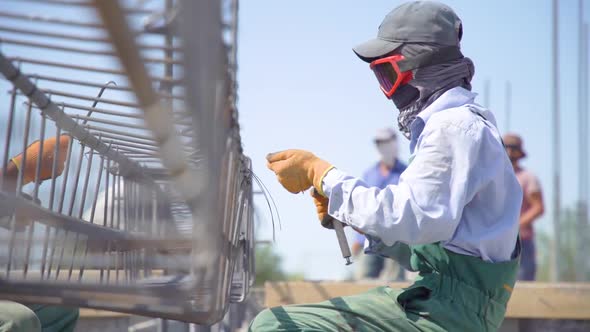 hands of builder on reinforcement works