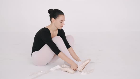Closeup of a Ballerina Putting on a Pointe on Her Foot