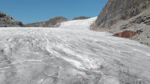 Glacier ice sheet crevasses and cracks, aerial reveal Hardanger Glacier Norway