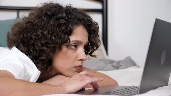 Close Up Hispanic Curly Woman Student Uses Laptop Search Information on Internet