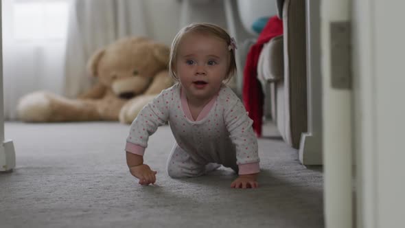 Close up of caucasian baby crawling on the floor at home